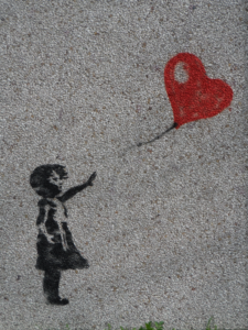Illustration showing girl reaching up toward a heart kit