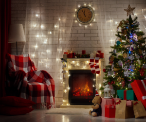 The perfect Christmas, photo shows beautiful living room setting with decorated tree, fireplace and cosy fireside chair.