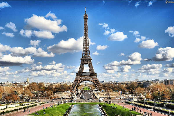 Photo of Eiffel Tower and surrounding Paris. One place I dreamed was PARIS, because of classroom French classes. Mrs. Walker’s black and white pictures of the sidewalk cafes, the Eiffel Tower, and Notre Dame inspired me. 