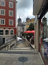 A walkway in Portugal alongside red building 